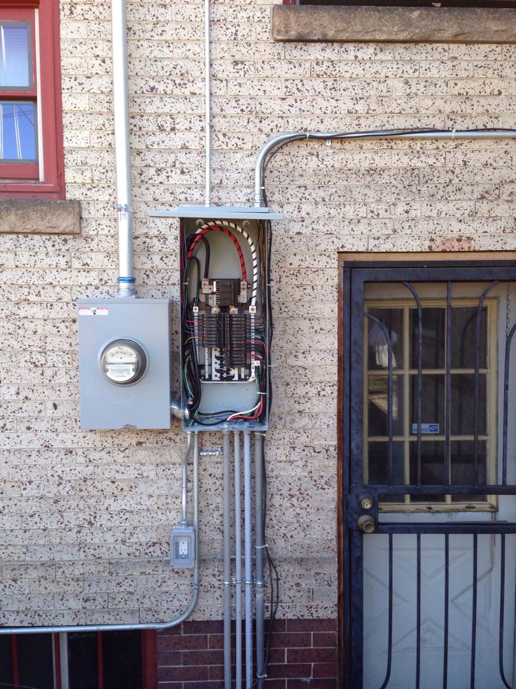 Exterior electrical panel installation on a brick home by B-Well Electric
